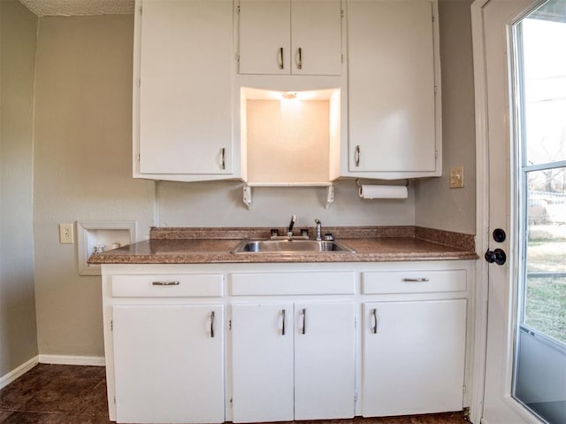 kitchen featuring white cabinetry, a wealth of natural light, and sink