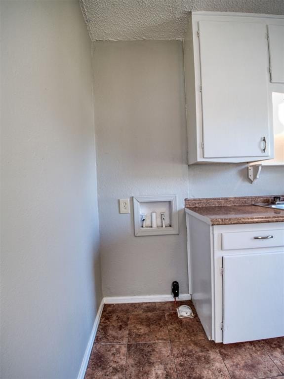 laundry area with washer hookup and a textured ceiling