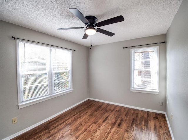 unfurnished room with ceiling fan, dark hardwood / wood-style flooring, and a textured ceiling