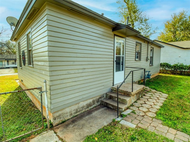 view of side of home featuring a yard