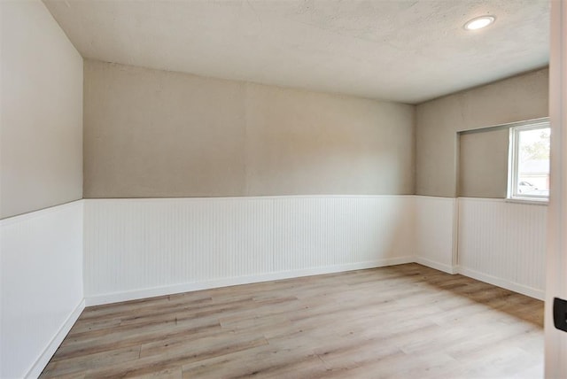 spare room featuring light hardwood / wood-style flooring