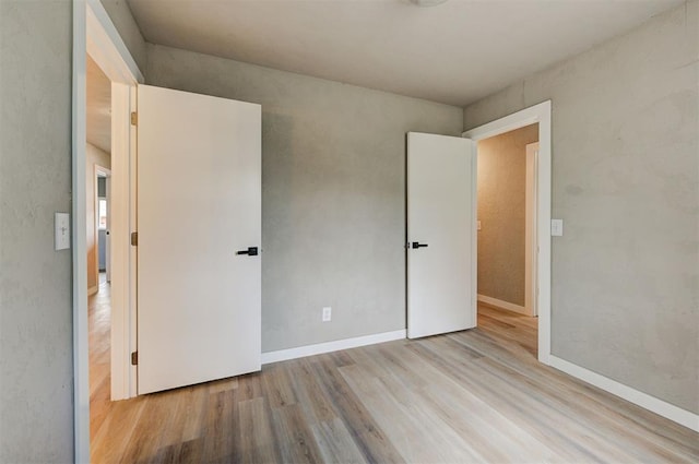 unfurnished bedroom featuring light wood-type flooring