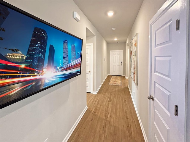 corridor with hardwood / wood-style flooring