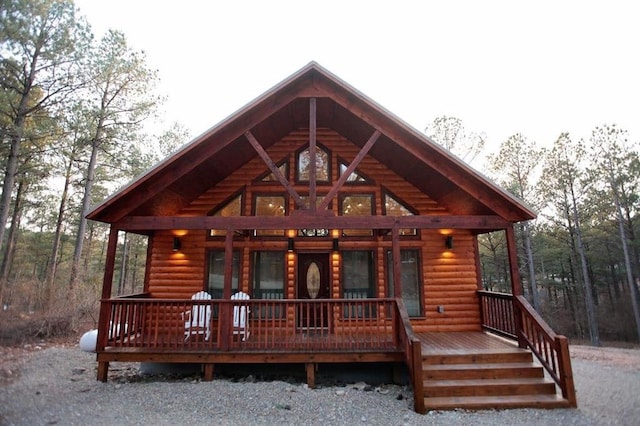 rear view of house featuring covered porch