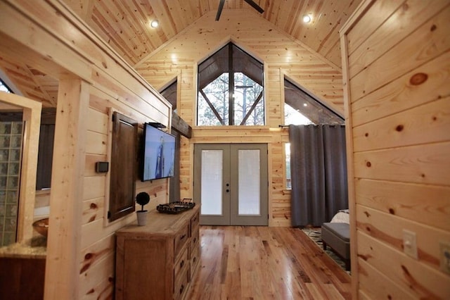 doorway to outside featuring french doors, high vaulted ceiling, wood walls, wood-type flooring, and wood ceiling