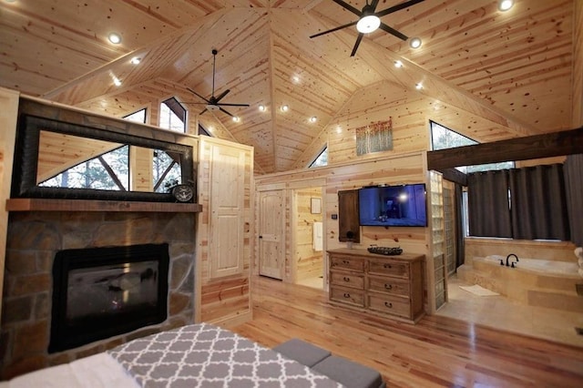 bedroom with wood ceiling, light wood-type flooring, a fireplace, and wooden walls