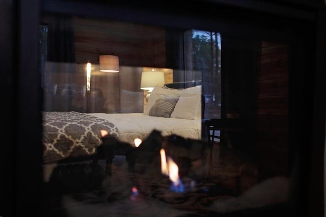 bedroom featuring wood walls