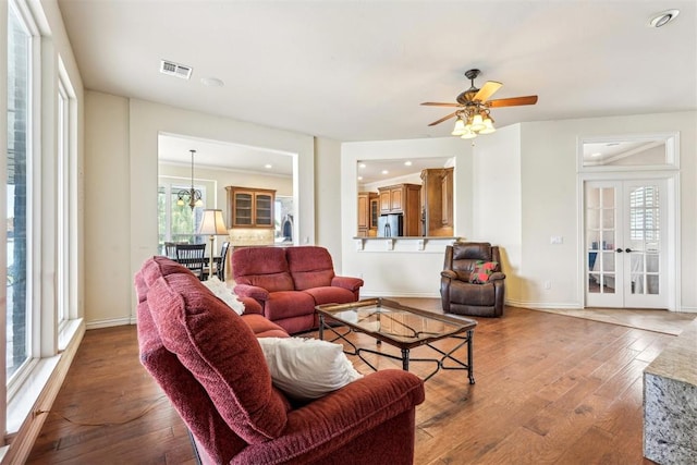 living room with french doors, a healthy amount of sunlight, and wood-type flooring