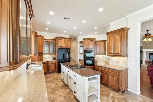 kitchen with a center island, black appliances, crown molding, sink, and decorative backsplash