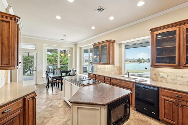 kitchen featuring black appliances, sink, ornamental molding, tasteful backsplash, and a kitchen island