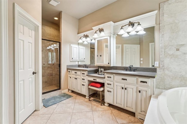 bathroom with tile patterned flooring, vanity, and plus walk in shower