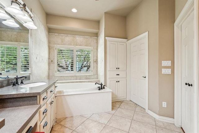 bathroom featuring tile patterned flooring, vanity, and a bathtub