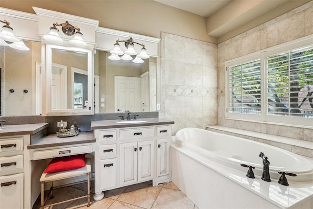 bathroom featuring tile patterned floors, a washtub, and vanity