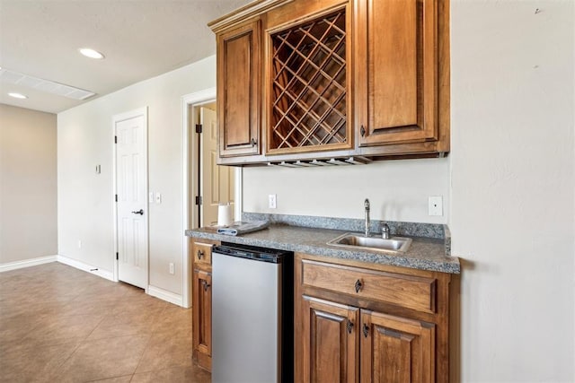 kitchen featuring dishwasher, light tile patterned flooring, and sink