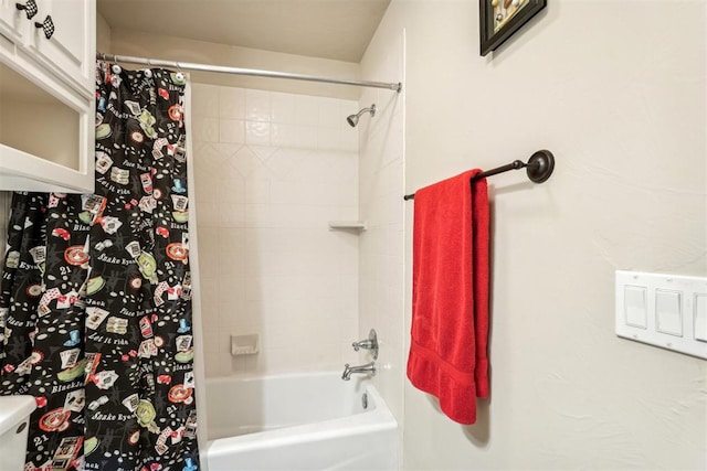 bathroom with shower / tub combo with curtain and toilet