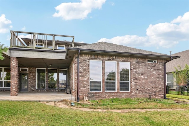 back of house with a yard, a balcony, and a patio area