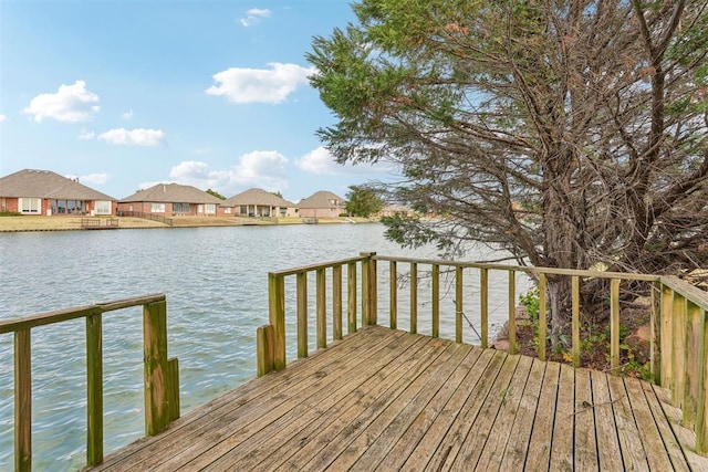 wooden terrace featuring a water view