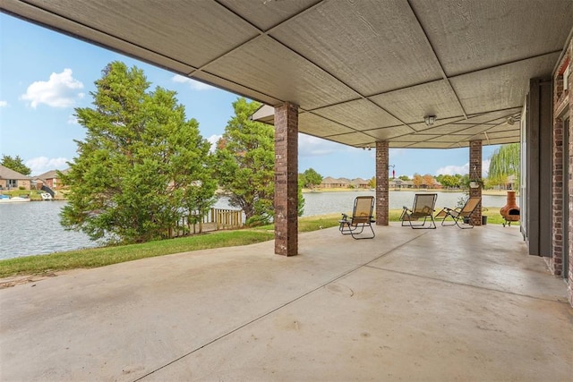 view of patio with a water view