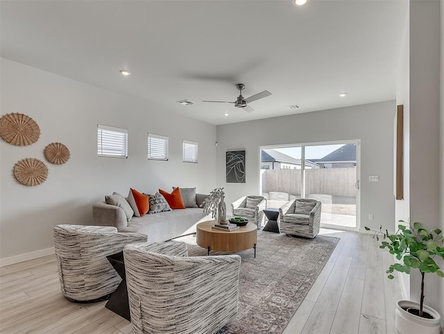 living room featuring ceiling fan and light wood-type flooring