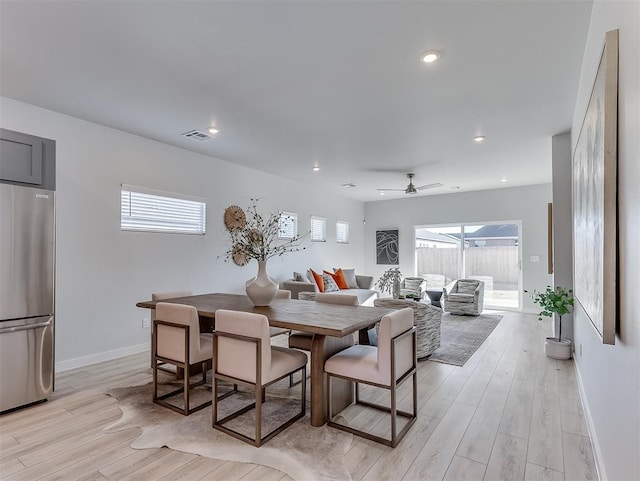 dining room with ceiling fan and light hardwood / wood-style flooring