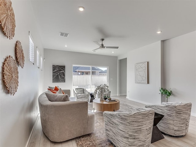 living room with ceiling fan and light hardwood / wood-style floors