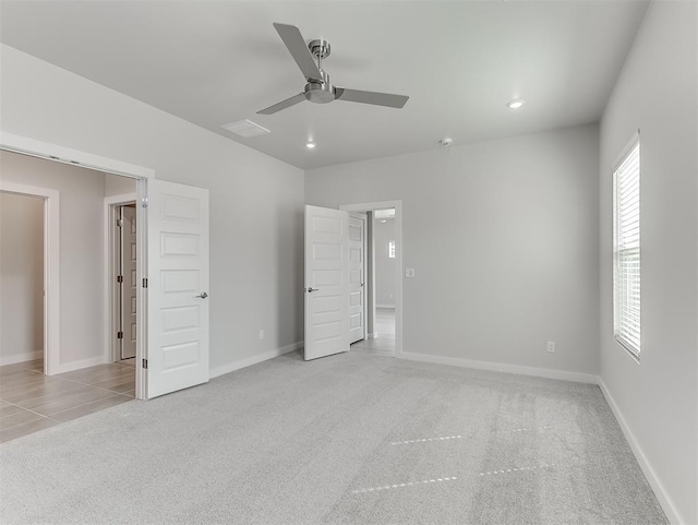 unfurnished bedroom featuring ceiling fan and light carpet