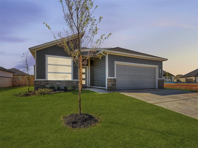 view of front of home featuring a lawn and a garage