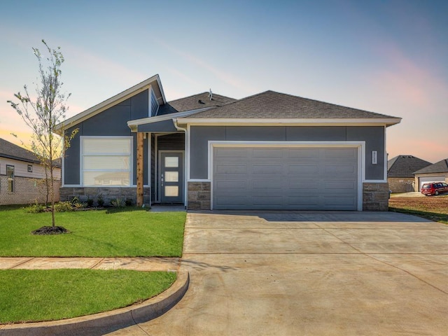 view of front of property featuring a garage and a lawn