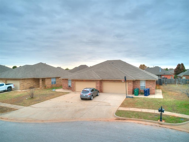 ranch-style house featuring a front lawn and a garage