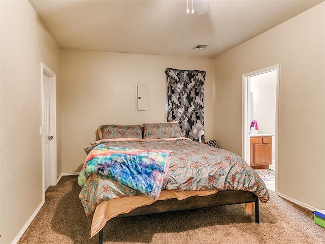 carpeted bedroom with ceiling fan, ensuite bathroom, and electric panel