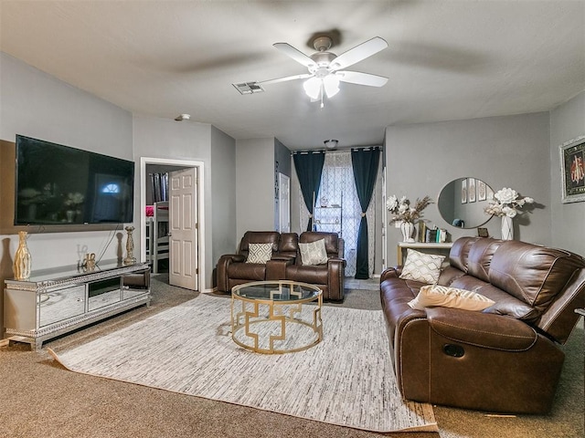 carpeted living room featuring ceiling fan