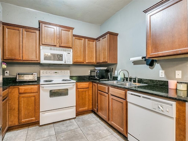 kitchen with sink, white appliances, and light tile patterned floors