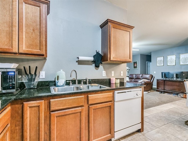 kitchen featuring sink, dishwasher, and light tile patterned flooring