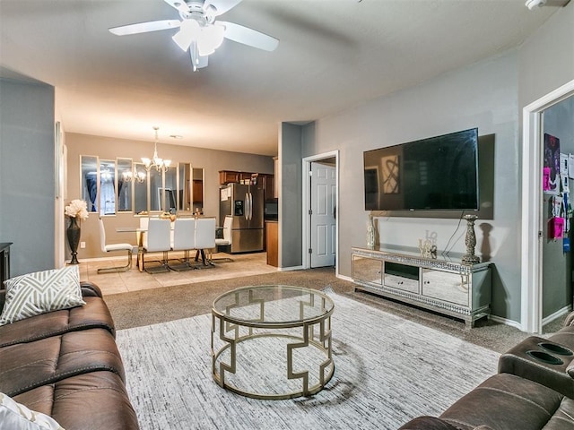 living room featuring ceiling fan with notable chandelier and carpet