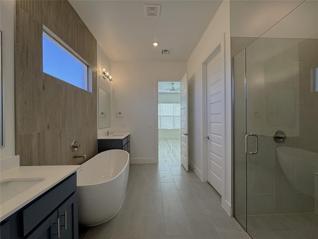 bathroom featuring ceiling fan, vanity, tile patterned flooring, and independent shower and bath