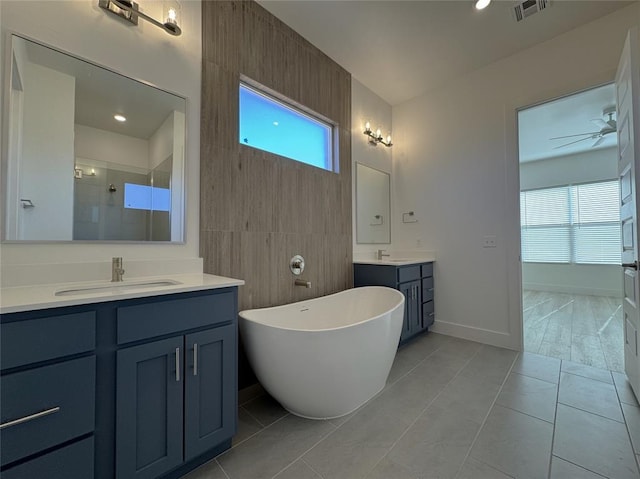 bathroom featuring ceiling fan, a wealth of natural light, tile patterned floors, and vanity