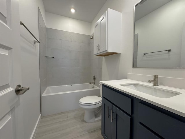 full bathroom with toilet, tiled shower / bath combo, and vanity