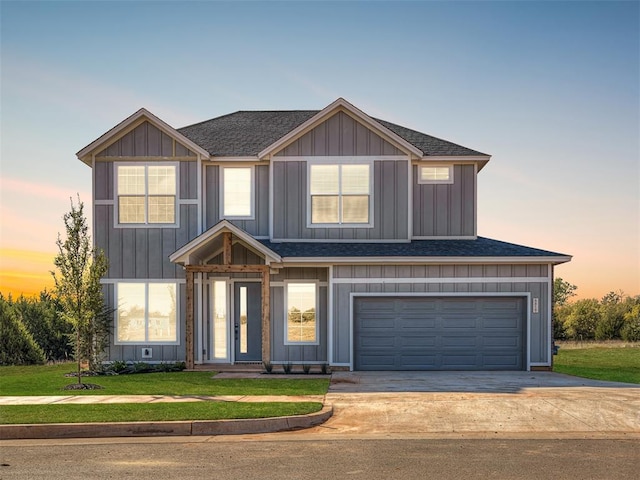 view of front of property featuring a lawn and a garage