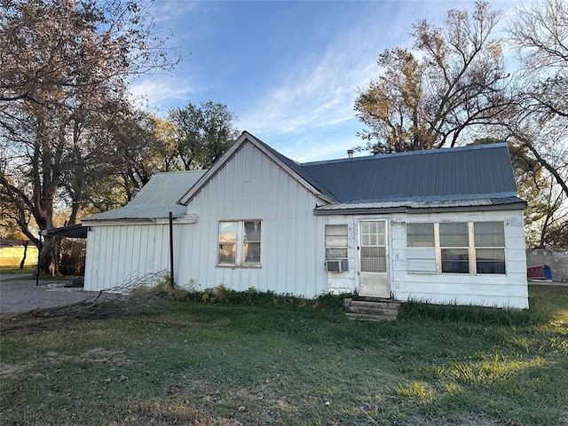 rear view of house featuring a yard and cooling unit