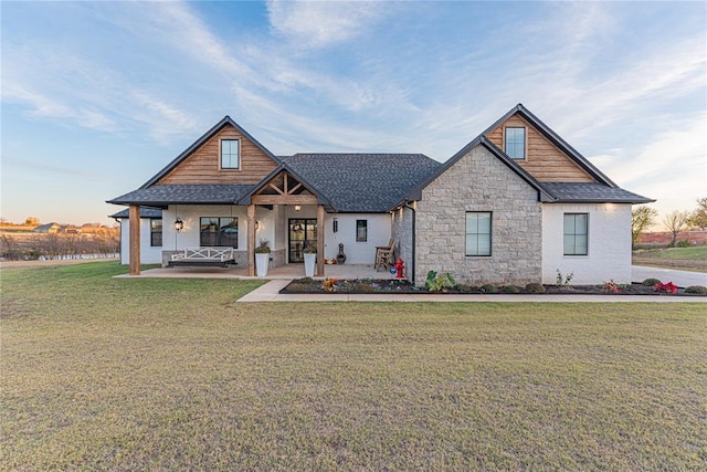 2063 County Road 1336, Blanchard, OK 73010 - view of front of house with roof with shingles, covered porch, a front yard, and stone siding