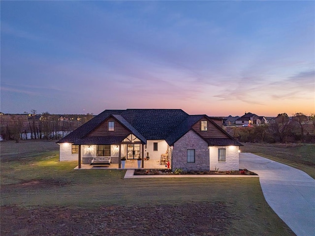 2063 County Road 1336, Blanchard, OK 73010 - view of front of house with a front yard, stone siding, driveway, and a porch