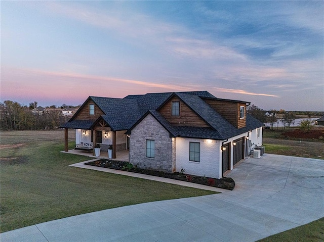 2063 County Road 1336, Blanchard, OK 73010 - view of front of property with stone siding, driveway, a yard, covered porch, and a shingled roof