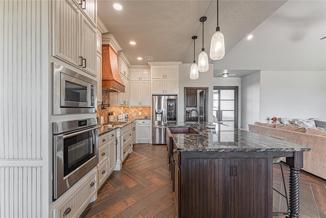 2063 County Road 1336, Blanchard, OK 73010 - kitchen featuring open floor plan, a kitchen breakfast bar, appliances with stainless steel finishes, an island with sink, and dark stone counters