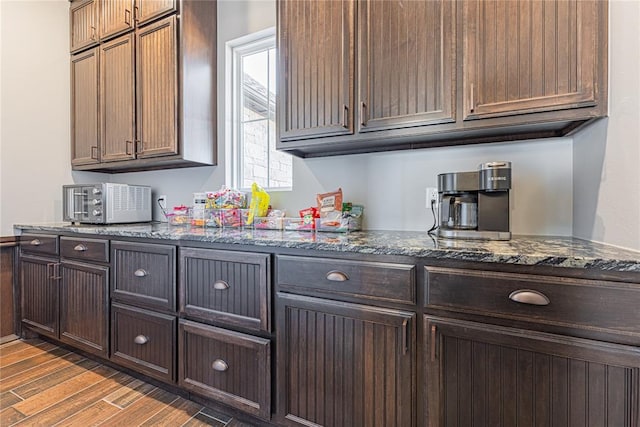 2063 County Road 1336, Blanchard, OK 73010 - kitchen with light wood finished floors, dark stone countertops, and dark brown cabinetry
