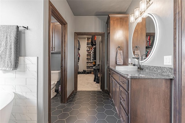 2063 County Road 1336, Blanchard, OK 73010 - bathroom with vanity, a freestanding bath, and a spacious closet