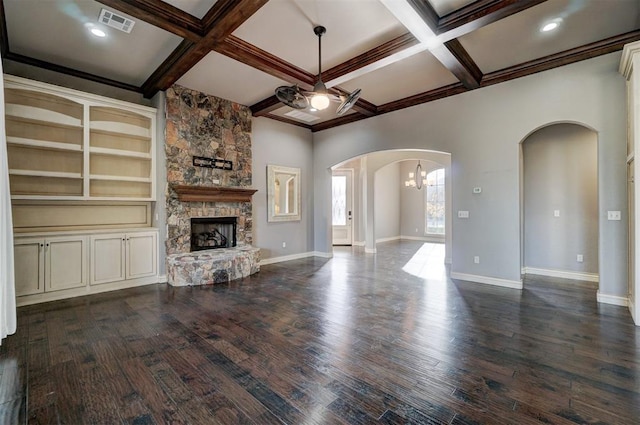 unfurnished living room featuring a fireplace, dark hardwood / wood-style floors, ceiling fan, crown molding, and coffered ceiling