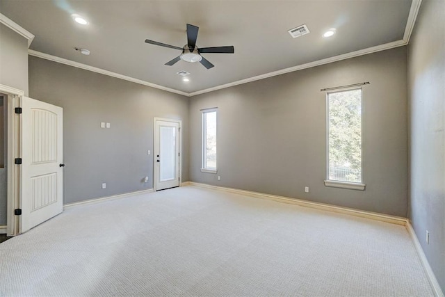 spare room with ceiling fan, ornamental molding, and light colored carpet