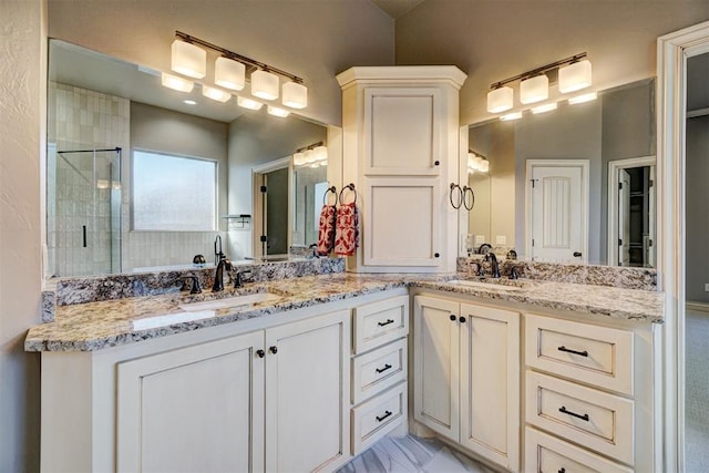 bathroom with a shower with door and vanity