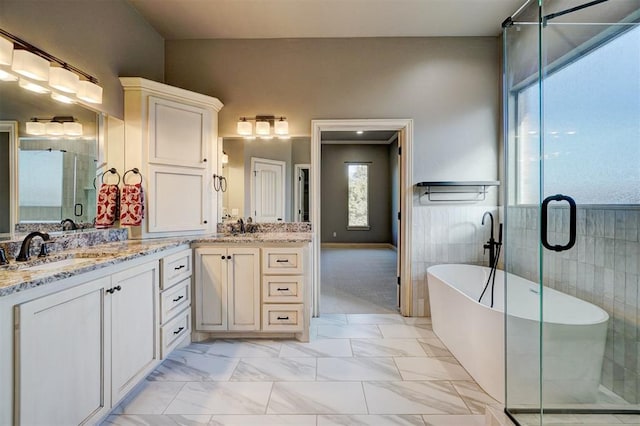 bathroom with tile walls, separate shower and tub, and vanity