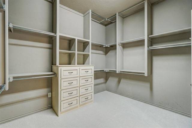 walk in closet with carpet